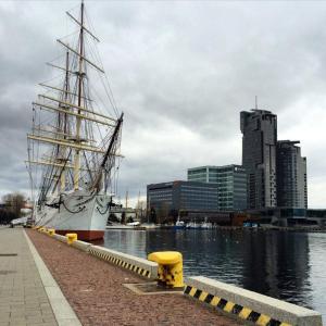una nave alta è ormeggiata vicino all'acqua di Sea Towers Gdynia a Gdynia