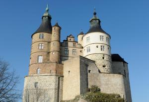 a castle with two towers on top of it at Appart'Hôtel "Le Phoenix" in Montbéliard