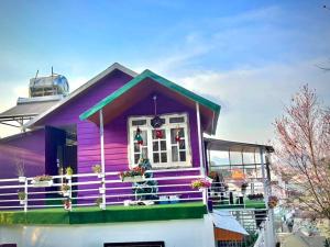 a purple house with christmas decorations on it at Nhà MIO in Khu Chi Lăng