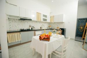 a kitchen with a table with a bowl of fruit on it at Rustic Homestay Bình Dương in Phú Lợi +6 photos