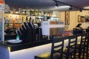 a bar with chairs and a counter in a restaurant at Milan Hotel & Restaurant in Phnom Penh