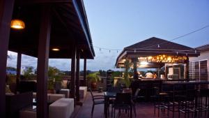 a restaurant with tables and chairs and a bar at Tropical Enclave Hotel in Accra