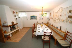 a dining room with a long table and chairs at Guesthouse Meri in Fažana +14 photos
