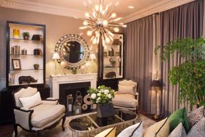 a living room with a fireplace and chairs and a chandelier at Hotel Monge in Paris