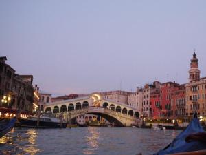 a bridge over a river in a city with buildings at Mimi's studios in Venice