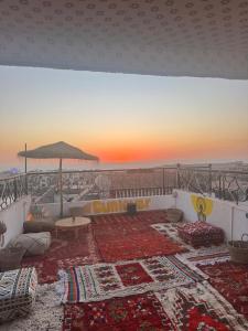 a living room with a couch and an umbrella at Ocean Charm in Tamraght Ouzdar