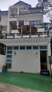 a large white house with a white garage at Baguio Brentwood Villas in Baguio