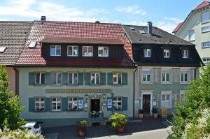 un edificio con techo rojo en Alte Post - Hotel Am Rhein-Ufer Laufenburg en Laufenburg