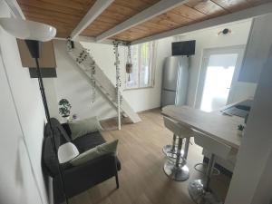 a living room with a table and a desk at Small apartment in center in Montesilvano