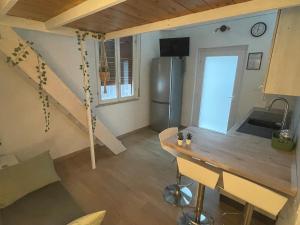 a kitchen with a wooden table and a refrigerator at Small apartment in center in Montesilvano