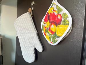 a hand towel and apron hanging on a wall at Comfortable Place, Great Location, Fiber Wifi, and Free Parking in Hayward