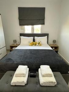a bedroom with a large bed with two towels on it at Alexandra's garden in Paliouri +54 photos