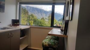 a kitchen with a large window with a view of a mountain at Remarkable studio,close to airport in Queenstown