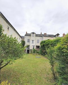 a large white house with a yard in front of it at Maison Loire & Cé'rénité in Les Ponts-de-Cé