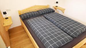 a bed in a small room with two night stands at Ferienhaus auf dem Land in Zell im Fichtelgebirge