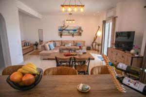 a living room with a table with fruit on it at Galanos villa in Krotiri