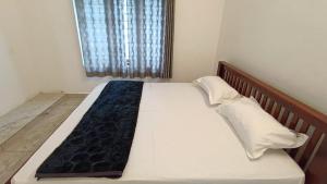 a large bed in a room with a window at Dolmens Castle in Marayoor +1 photo