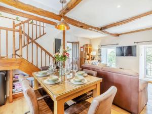 a living room with a table and a couch at Inglenook Cottage in Ingleton