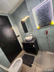 a bathroom with a toilet and a sink and a mirror at Khas Mahal Homestay in Agra +87 photos