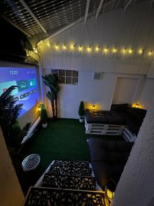 a living room with a couch and a large screen at Fresh 2 Room Appartment near to Baden-Baden in Baden-Baden