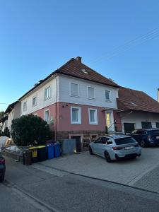 a white car parked in front of a house at Fresh 2 Room Appartment near to Baden-Baden in Baden-Baden