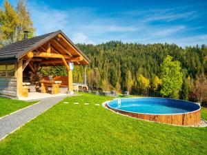 a gazebo and a swimming pool in the grass at Villa in Nowy Targ with Mountain Views & Pool in Nowy Targ