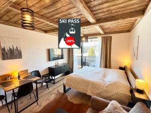 a bedroom with a bed and a dining room at CORSO RUSTIC Luxury Apartment Harrachov, Ski in - Ski out, Free Parking, High Speed Wi-fi, Smart TV in Harrachov