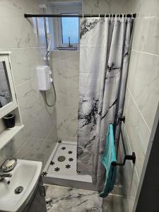 a bathroom with a shower and a sink at Our beautiful little house makes you stay magical in Bristol