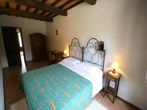 a bedroom with a bed and two tables with lamps at Holiday Home in Montone with Pool & Terrace in Montone