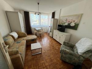 a living room with a couch and chairs and a table at Apartman Lavanda in Živinice