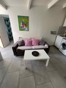 a living room with a couch and a table at M 10 maison avec spa et jardin proche de la mer in Marseille