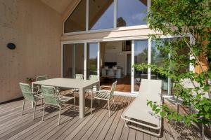 a patio with a table and chairs on a deck at Am Grassnitzberg in Grassnitzberg