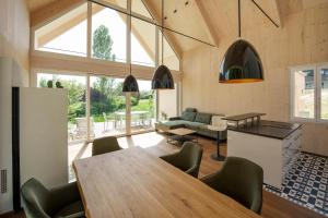 a kitchen and living room with a table and chairs at Am Grassnitzberg in Grassnitzberg +12 photos