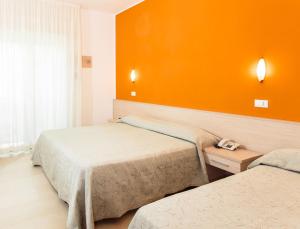 A bed or beds in a room at Hotel Villa Ombrosa
