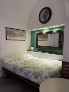 a bedroom with a bed and a clock on the wall at The Lodge in Naples