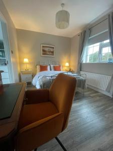 a bedroom with a bed and a couch at Elder Grove House in Castleisland