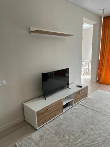a living room with a flat screen tv on a wall at Tamarix in Almaty