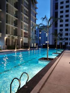 a swimming pool in a city at night at Condo in Jalan Ampang- near KLCC IJN Gleneagles HKL TRX in Kuala Lumpur