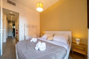 a bedroom with two beds with towels on them at PIAZZA MAGGIORE-Luxury Apartment-Elegant Terrace in Bologna