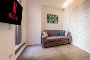 a living room with a couch and a tv at PIAZZA MAGGIORE-Luxury Apartment-Elegant Terrace in Bologna