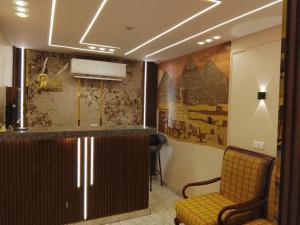 een wachtkamer met een bar en twee stoelen bij Red pyramids view hotels Foreiigners only in Caïro