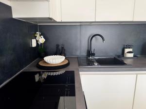 a kitchen with a sink and a bowl on the counter at Romantic 3 Bedroom Apartment 3min from the beach in Kruševo +45 photos