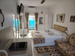 a living room with a bed and a couch at Studio Ultracentral OGLINDA in Arad