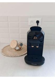 a toaster sitting on a counter next to a hat at Villa Emeraude in Saint-Louis