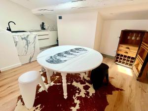 a white table and chairs in a room with a kitchen at Maison BOBLEU in Bandol +43 photos