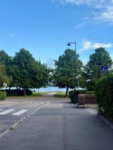 an empty street with a street light and the ocean at Ellis Seaside Suite in Helsinki