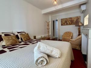 a bedroom with a bed with a towel on it at Maison BOBLEU in Bandol