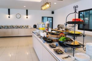 a buffet line with food on it in a restaurant at Shewin de Bangkok in Ban Bang Bamru