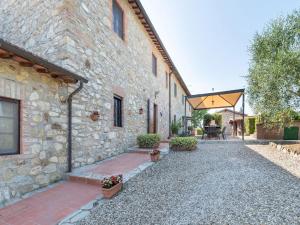 an external view of a stone building with a patio at Sun-kissed holiday home in Monti di Sotto