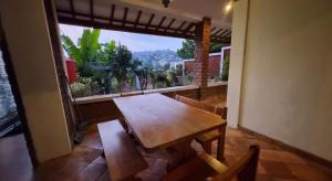 a wooden table in a room with a large window at Ncie property in Cangkuang